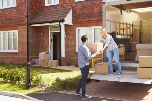 Professional movers handling boxes and furniture for a Pimlico flat relocation