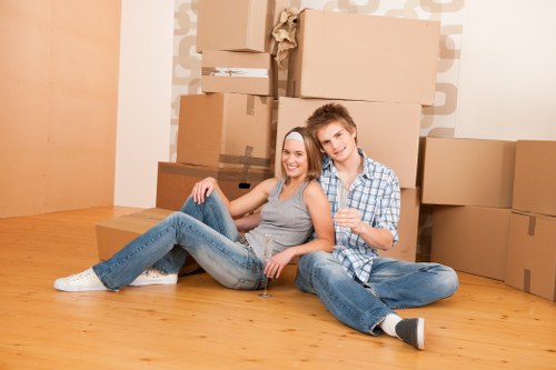 Moving team loading household items into a van during a UK removal service