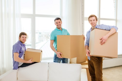 Team using safe manual handling methods with secured moving equipment